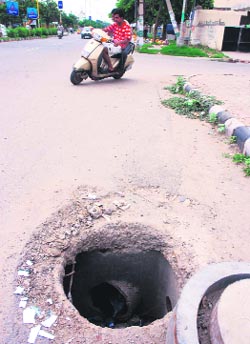 An uncovered manhole on the sector 12-13 dividing road near the mini secretariat in Karnal on Wednesday which poses a danger to road users. 