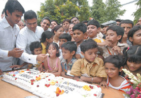 The Indian Youth Congress (IYC) president Ashok Tanwar with Delhi Youth Congress president Anil Chaudhary and children celebrates the 39th birthday of Congress general secretay Rahul Gandhi at the IYC office in New Delhi on Thursday. 