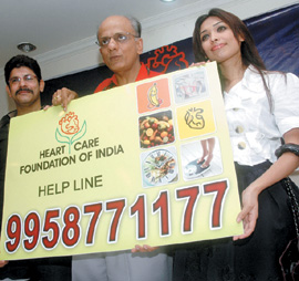 The Heart Care Foundation of India president Dr K.K. Aggarwal with model Priyanka Sharma and designer Rahul launches the Foundations helpline in New Delhi on Thursday. 