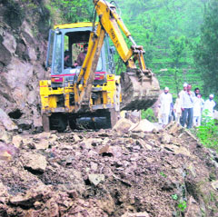 A JCB machine at work to clear debris from the Mandi-Rewalsar road near Ghor on Thursday.