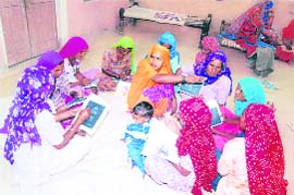 Women taking their daily lessons under the literacy campaign in a Fatehabad village will soon have their own choupals.