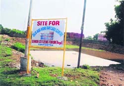A hoarding displaying the project site for the old age centre to be constructed by the Senior Citizens Forum, Kurukshetra.