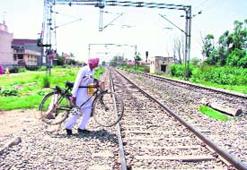 DANGER ZONE: The abandoned railway crossing near Aggarsain chowk gives liberty to the commuters to cross the tracks at will.