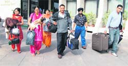 Passengers of the Singapore Airlines come out of the hotel, where they were put up after a snag in the aircraft, to board a bus to catch flight in Amritsar