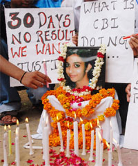 Arushis friends and well wishers hold a candlelight march demanding justice for her near the Parliament House in New Delhi on Friday.