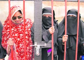 Members of the Muslim Khawateen Markaz as they hold protest inside the cage, demanding release of Kashmiri men who have been detained in various jails across the country