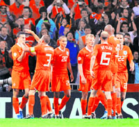 Dutch players celebrate at the end of the Group C football match against. Romania on Tuesday at the Stade de Suisse Wankdorf in Bern. The Netherlands play Russia in the third quarterfinal on Saturday.