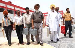 Polling agents carrying electronic voting machines and other polling materials in Bathinda