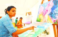 An artist explains the theme of her painting at a workshop at Virsa Vihar in Jalandhar