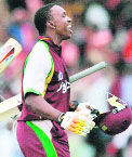 Dwayne Bravo celebrates after hitting a six off Shane Watson to win the T20 cricket match at Kensington Oval in Bridgetown.