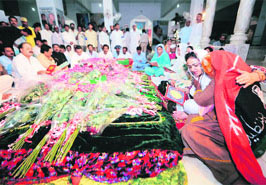 Supporters of Pakistan People's Party gather around the grave of Benazir Bhutto at her family graveyard in Ghari Khuda Buksh on Saturday on her 55th birth anniversary.