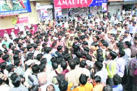 A mob protests on the Mall Road in Solan