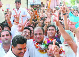 Congress workers celebrate the victory of Iqbal Masih Gill in the MC byelection for ward 41 in Jalandhar on Sunday.