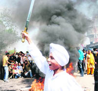 Sikhs block the Jammu-Pathankot National Highway in protest against the Mumbai killing in Jammu on Sunday.