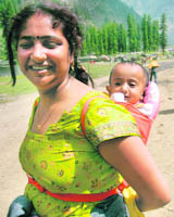 A woman along with her child en route the Amarnath yatra in Srinagar on Sunday.