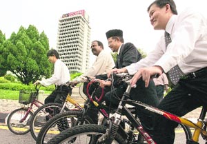 Malaysias MPs from the opposition parties cycle to the Parliament House in protest against the petrol price hike in Kuala Lumpur on Monday.