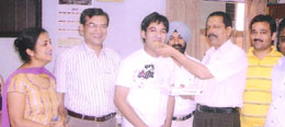 Nipun Bansal being offered sweets on his success.