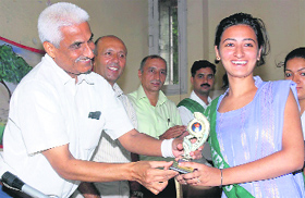 Deputy commissioner B.S. Malik presents a memento to a participant of a declamation contest in Karnal on Tuesday. 