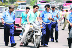 Traffic policemen challan a violator in Jammu on Tuesday.