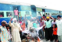 Members of various Sikh organisations block rail traffic on the Pathankot-Jalandhar line in Bashirpur demanding arrest of Dera Sacha Sauda chief on Tuesday. 