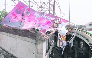 A portion of a building collapsed after an illegal hoarding fixed atop fell on its roof in Ludhiana on Tuesday. 