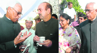 N.N. Vohra talks to Chief Minister Ghulam Nabi Azad after taking oath as Jammu and Kashmir Governor in Srinagar on Wednesday; and (right) N.N. Vohra with his wife.