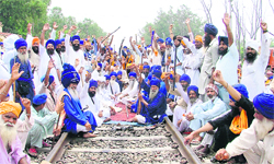 Protesters squat on a railway track at Mullanpur on the Ludhiana-Ferozepur section