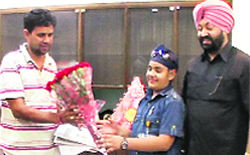 Yuvraj Sehdev being presented a bouquet by deputy commissioner Sumer Singh Gurjar in Ludhiana
