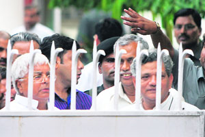 Railway minister Lalu Prasad Yadav (left) and CPM leader Sitaram Yechury speak to mediapersons from behind a gate following a UPA-Left meeting on the nuclear deal in New Delhi on Wednesday.