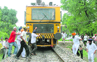 Protesters block a train during the rail roko in Patiala