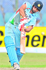 Suresh Raina hits a stroke during a match between India and Hong Kong for The Asia Cup at The National Cricket Stadium in Karachi on Wednesday.