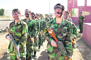 Kurdistans female police trainees march with camouflage paint on their faces during training at a police academy in Arbil, 310 km north of Baghdad, on Monday.