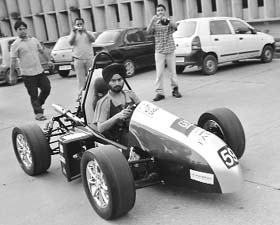 A Thapar University student with the Formula car on university campus in Patiala