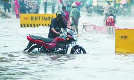 CITIZENS SUFFER: Waterlogging and traffic snarl at ITO in New Delhi on Thursday.