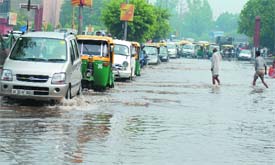 CITIZENS SUFFER: Waterlogging and traffic snarl at ITO in New Delhi on Thursday.