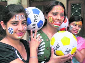 Football buffs with painted faces in Faridabad on Thursday.