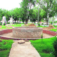 A view of the ongoing construction work at Shahidi Park, adjacent to the historical Buwa Wala pond and the medieval mausoleums in Jhajjar.