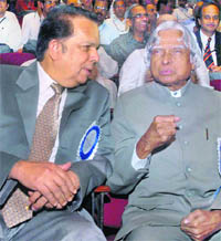 Former President A.P.J. Abdul Kalam interacts with ISRO chairman G. Madhavan Nair in Bangalore on Thursday.