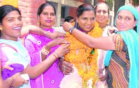 Eunuch leader Santosh Kumari Mahant is being garlanded by members of her community