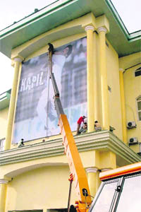 Comeback: Kapil Devs poster being reinstalled at PCA Stadium in Mohali on Friday.