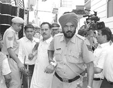 Head constable Pardeep Kumar, who was caught with a woman, being taken to the police station in Ambala on Friday.