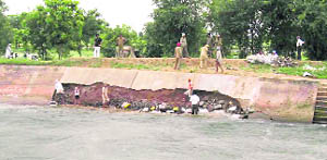 Workers repair the cracks in the Bhakra channel near Sidhwan village in Fatehgarh Sahib.