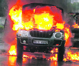 A Scorpio catches fire due to short circuit in Prem Nagar locality in Ambala on Friday.
