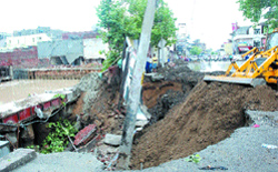 The road which caved in after heavy rain lashed city