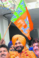 BJP workers celebrate with party leader Navjot Singh Sidhu, who was announced BJP nominee for the Amritsar Lok Sabha constituency in the coming general election, in Amritsar on Friday.