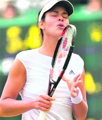 Serbias Ana Ivanovic reacts during her Wimbledon match against Chinas Jie Zheng at The All England Tennis Club in London