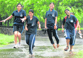 Players of Chandigarh softball team enjoy after their match was postponed due to heavy rain at Panjab University on Saturday.