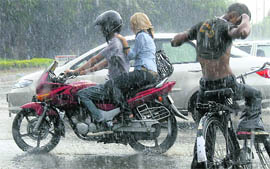 A couple is caught in downpour at the Press trafficlights in Sector 18, Chandigarh, on Saturday.