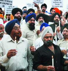 Members of the Delhi unit of SAD hold a candlelight Insaf march at Bangla Sahib Gurdwara in New Delhi on Saturday.