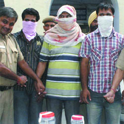 Three persons arrested by the Delhi Police for extortion at Karol Bagh police station in New Delhi on Saturday.